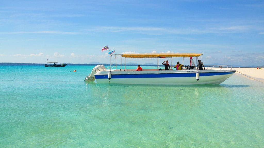 Tourists in a boat enjoying marine life at Gozo island