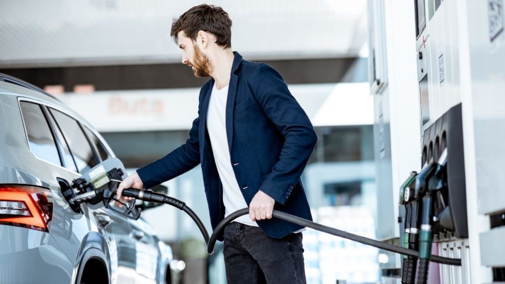 People getting fuel from petrol station near them