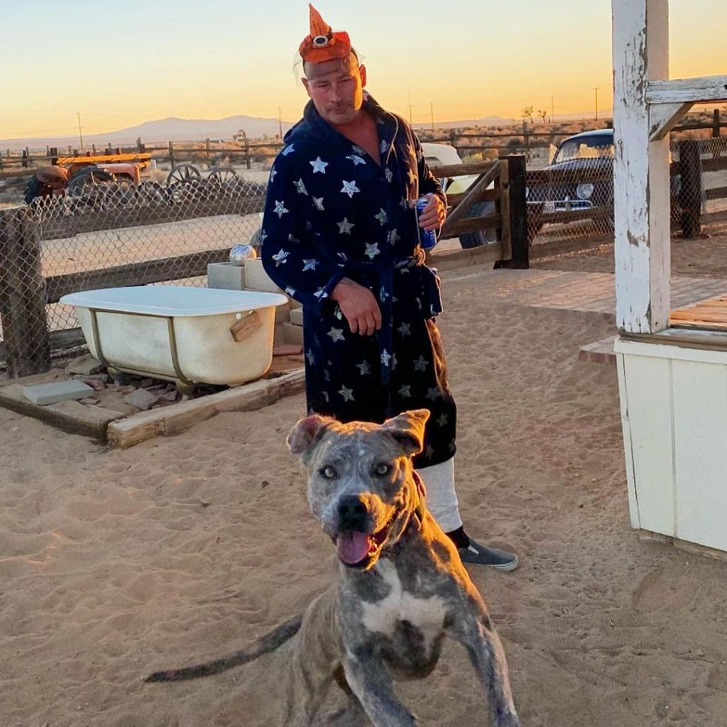 Ian posing with his dog .