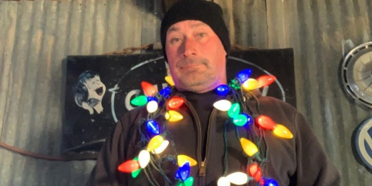 Ian Roussel wearing lights all over him in his garage