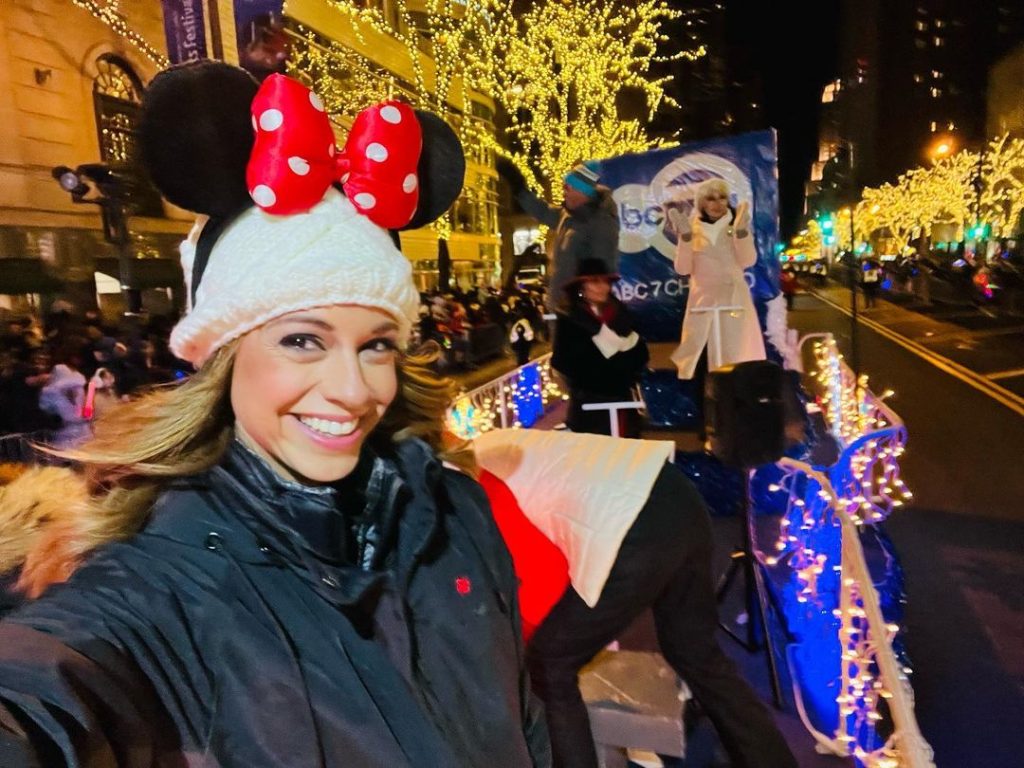 Cheryl taling a selfie wearing a minnie mouse cap and balck jacket.