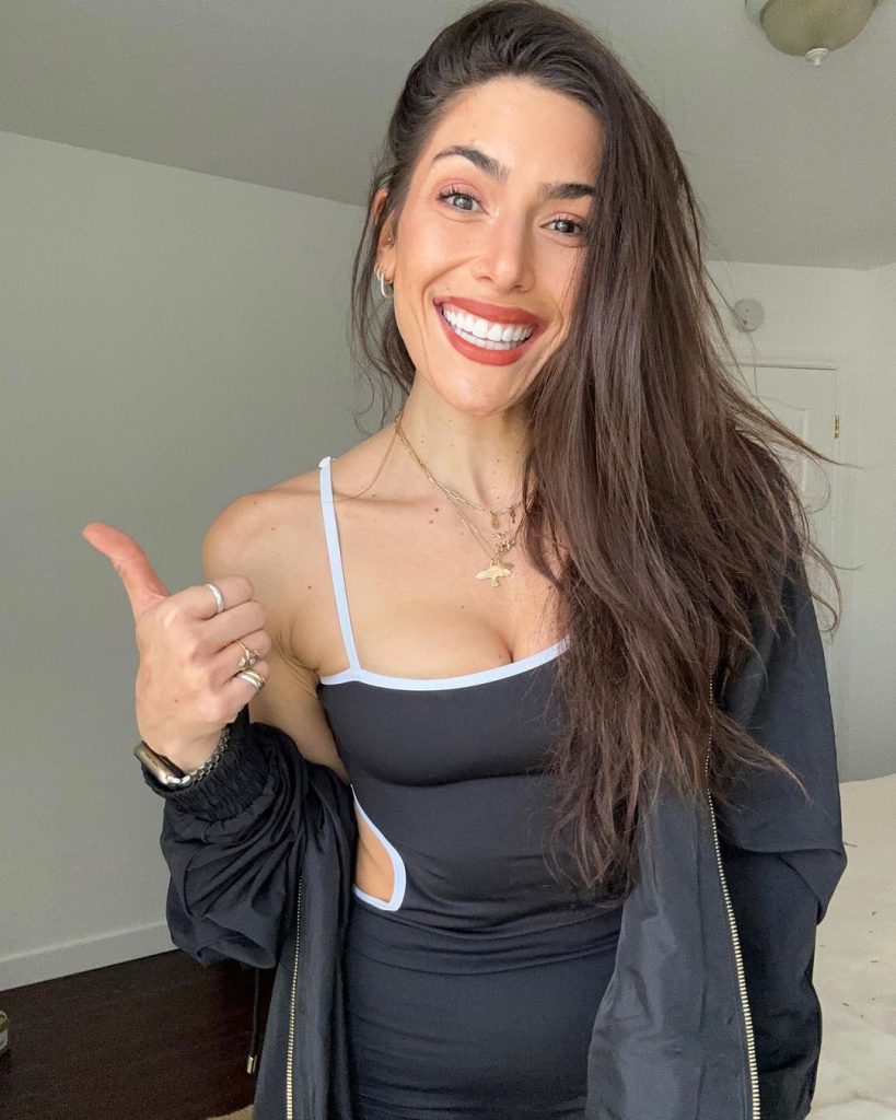 Nikki wearing black clothes posing doing thumbs up