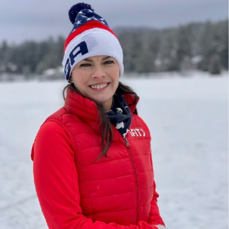 Nancy Kerrigan wearing a red jacket and red cap